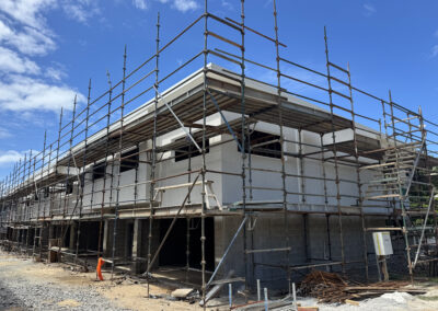 Exterior painting in progress on a new apartment building