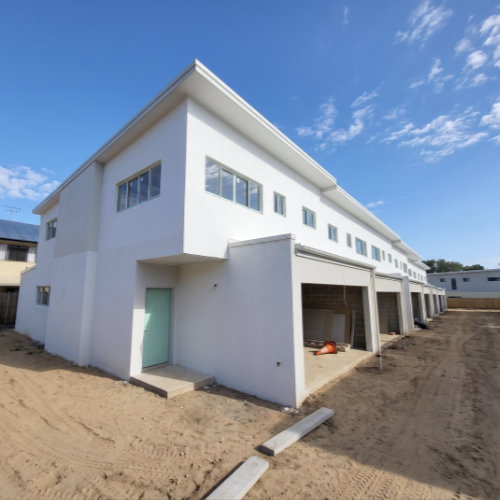 Exterior painting in progress on a multi-storey block of residential units. Exterior painting in progress on a multi-storey block of residential units.